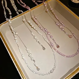 Elegant vintage layered pearl beaded necklace with shimmering teardrop crystal pendants for women