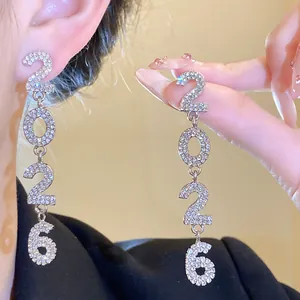 Detailed view of rhinestone-encrusted number 2026 drop earrings with silver pins