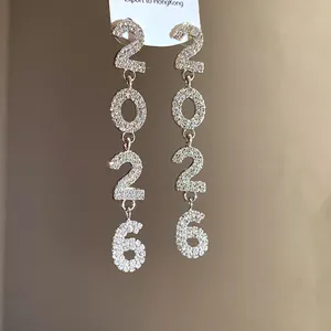 Detailed view of luxury 2026 number drop earrings fully encrusted with white crystals