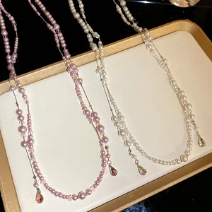 Detailed view of double-layer pearl necklaces with elegant crystal teardrop pendants