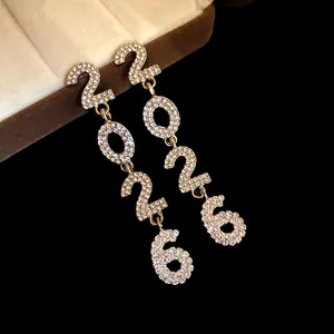 Close-up of luxury 2026 tassel earrings with sparkling rhinestones and silver needle.