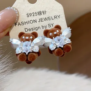 Detailed view of cute brown flocked teddy bear earrings with sparkling oval crystals