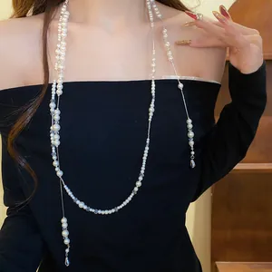 Exquisite detail view of a double-layer faux pearl necklace with rhinestone waterdrop pendants.