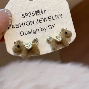 Detail view of brown flocked teddy bear stud earrings with S925 silver needle posts.