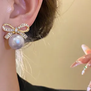 Elegant silver needle bow-knot stud earrings with pearl pendant for women