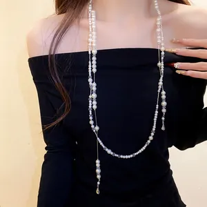 Elegant detail view of a double-layer pearl necklace featuring crystal beads and water drop pendant