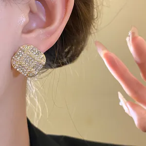 Close-up of elegant French retro square stud earrings with pearls and rhinestones