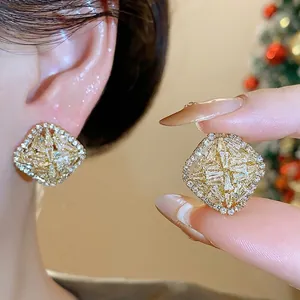 Elegant French style rhombus cubic zirconia stud earrings with a gold finish for women.