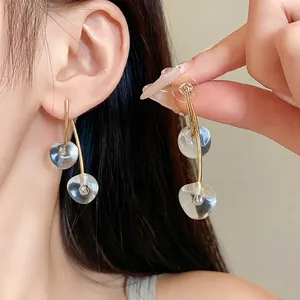 Elegant transparent cherry resin dangle earrings with minimalist gold-tone silver needles