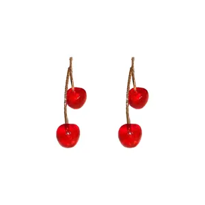 Pair of realistic red cherry resin dangle earrings with gold-toned stems