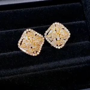 Macro view showing the exquisite sparkle of luxurious gold-toned rhombus zircon earrings