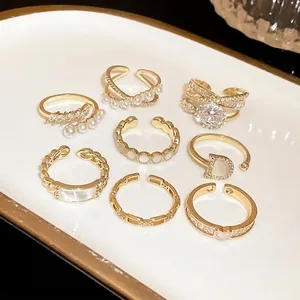 Elegant collection of gold-toned open rings featuring zircons, pearls, and minimalist designs