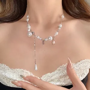 Elegant pearl necklace with rhinestone water drop tassel and silver chain on neck