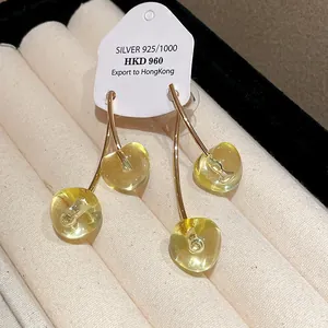 Cherry resin earrings with 925 silver needle on a display tag in a jewelry tray