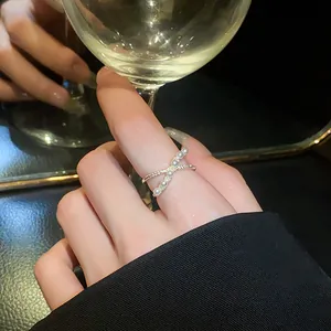 Elegant cross adjustable ring featuring delicate pearls and cubic zirconia stones
