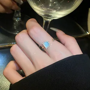 Detailed view of an elegant open ring featuring a zircon-encrusted D-shaped logo