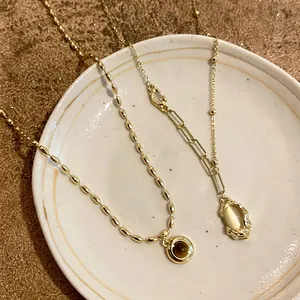 Vintage French gold-plated bamboo link necklace set featuring oval stone pendants