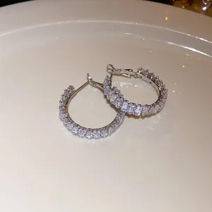 Detailed view of silver hoop earrings featuring sparkling baguette cut clear crystals