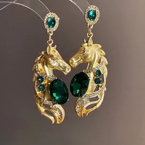 Exquisite vintage gold horse drop earrings featuring elegant green gemstones and crystals
