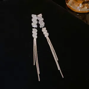 Detail of silver long tassel drop earrings with rectangular clear rhinestones