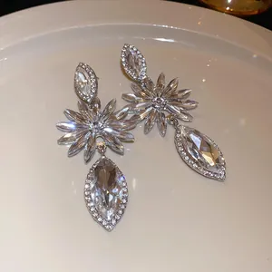 Macro view of sparkling silver-tone flower earrings with marquise-cut clear crystals