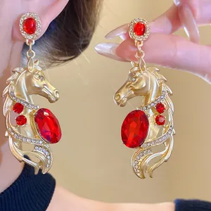 Exquisite vintage gold horse head earrings with red crystals and silver needles for women.