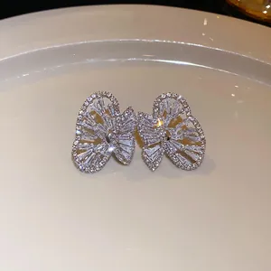 Close-up of sparkling butterfly earrings with silver needles and cubic zirconia