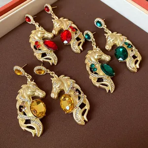 Close-up of vintage-style horse head dangle earrings with colorful rhinestones