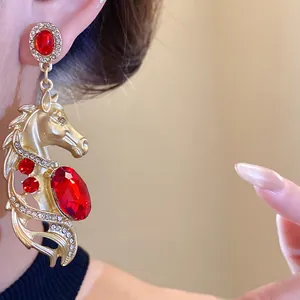 Macro view of a vintage-style horse earring with red gems and rhinestones
