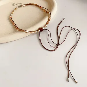 Vintage Maillard style leather cord necklace featuring polished wooden beads and adjustable chain