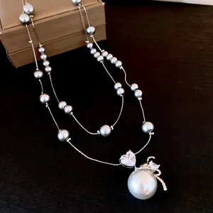 Elegant grey pearl necklace with a large round pearl and heart crystal pendant detail