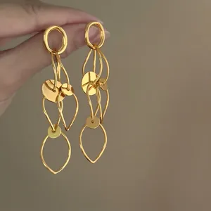 Elegant gold hollow circle tassel earrings detail highlighting the smooth metallic finish.