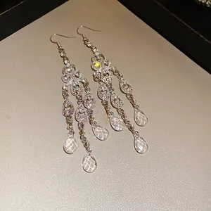 Close-up of luxury rhinestone water drop hollow tassel earrings in palace style