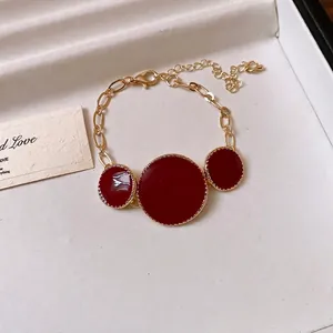 Elegant French vintage gold chain necklace featuring three red circular enamel pendants