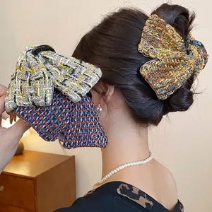 Elegant fabric plaid bow hair claw clip set showing multiple colors on model view