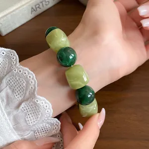 Close-up detail showing the marbled texture of this green acrylic beaded geometric bracelet