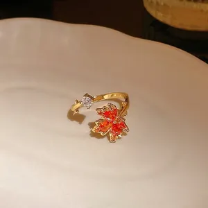 Elegant gold-plated adjustable ring featuring a vibrant orange maple leaf and zircon detail.