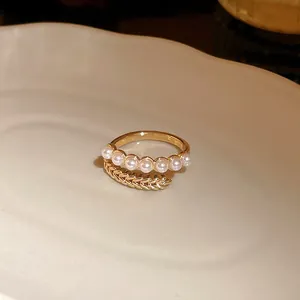 Elegant gold plated open ring featuring delicate pearls and unique wheat ear texture