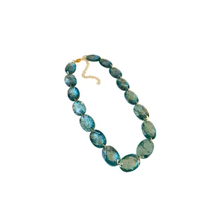 Vintage blue oval resin bead necklace featuring an elegant gold adjustable chain