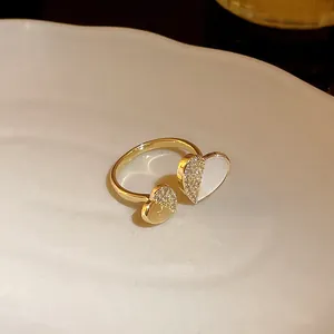 Close-up of elegant gold-plated heart-shaped open ring with sparkling cubic zirconia