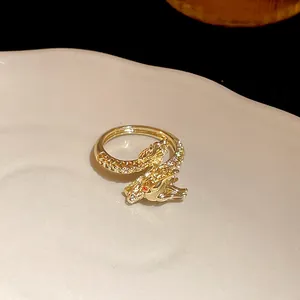 Detailed macro shot of a gold-plated dragon-shaped open ring featuring sparkly zircons.