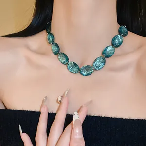 Vintage teal oval resin necklace worn as a minimalist collarbone chain for women