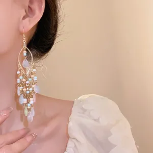 Bohemian bead teardrop tassel earrings with colorful charms for a chic ethnic look.