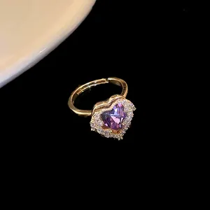Elegant gold-plated ring featuring a sparkling purple heart-shaped zircon gemstone detail.