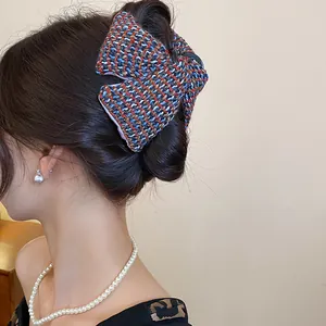 Close-up of a Korean style tweed woven fabric hair claw clip on a model's hair