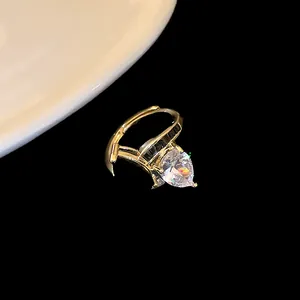 Macro view of gold plated wrap-around dragon ring with a sparkling pear-shaped zircon detail