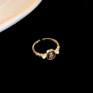 Macro detail of elegant gold-plated open ring featuring zircon dragon motif and pearls
