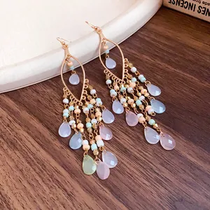 Detailed macro view of Bohemian beaded tassel hook earrings with colorful teardrop pendants