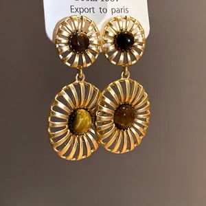 Vintage hollow oval earrings with a tiger's eye stone inlay in a matte golden finish