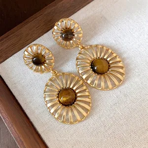 Vintage gold hollow oval earrings with tiger eye stone centers for a luxury look